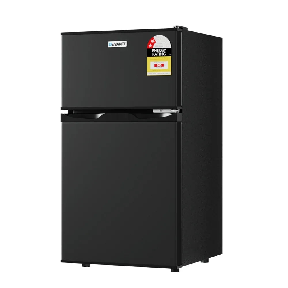 Black double door compact fridge freezer with energy rating sticker, isolated on white