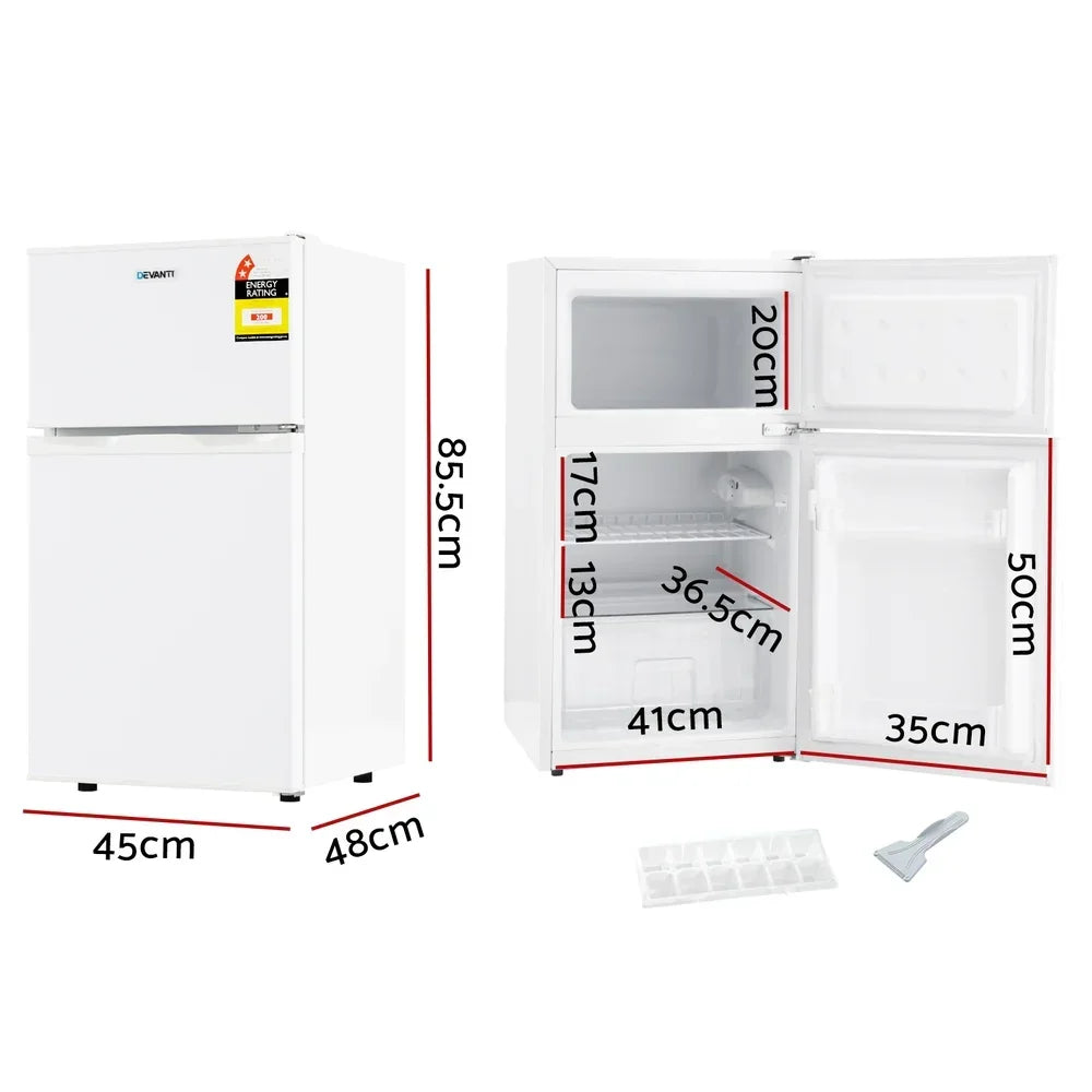 White compact bar fridge with freezer, doors open showing interior shelves, labelled dimensions.