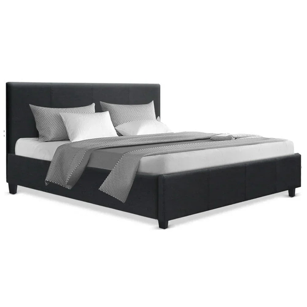 Modern queen bed frame with dark upholstery, padded headboard, and monochrome bedding.