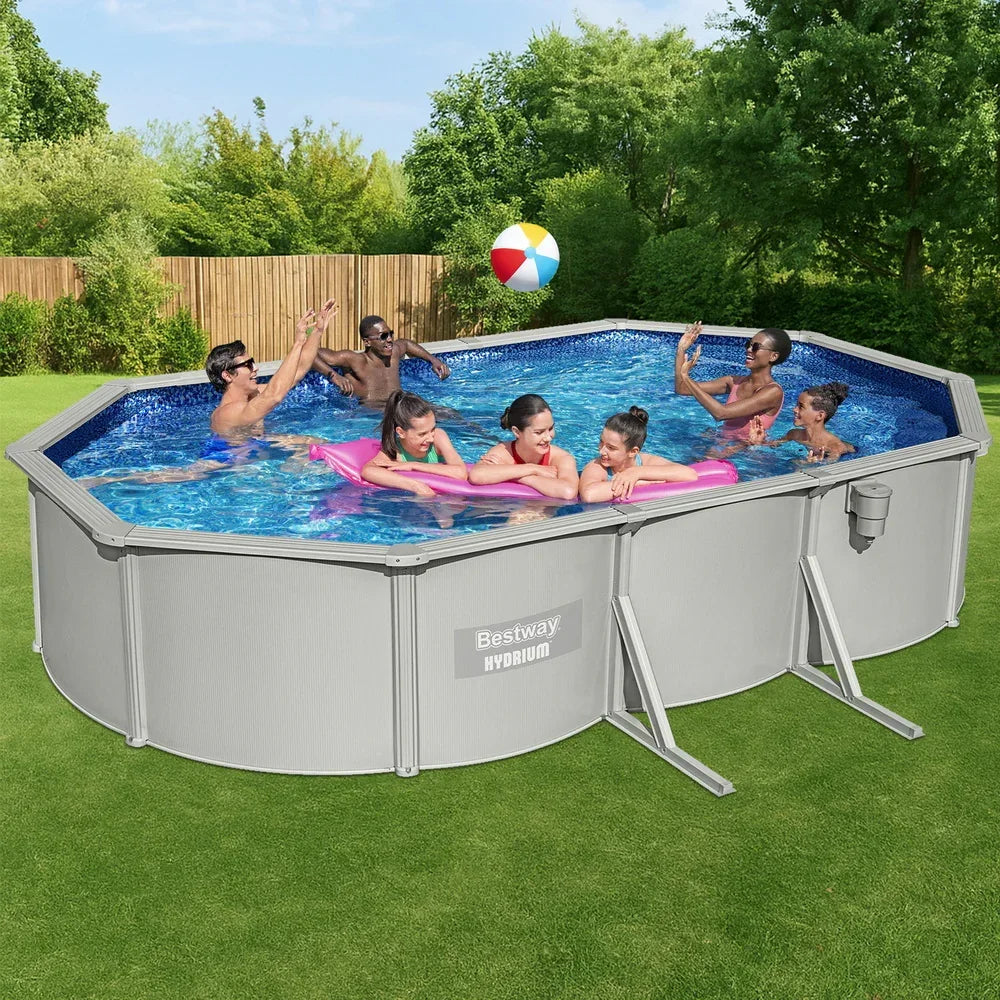 People playing in an above ground Bestway Hydrium pool with a beach ball in a backyard