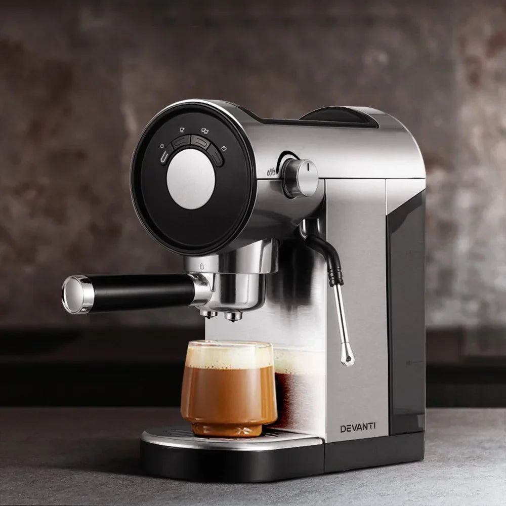 Stainless steel espresso coffee machine brewing a cappuccino in a glass cup