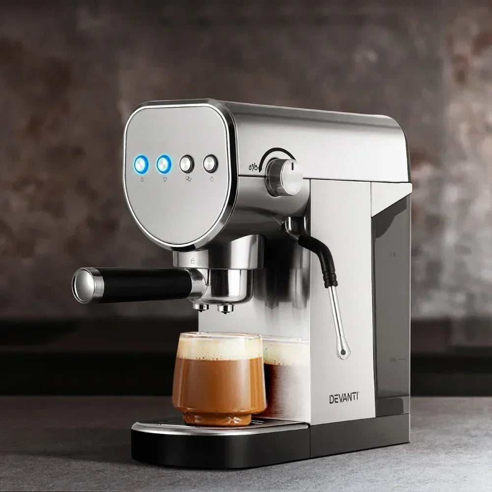 Stainless steel espresso coffee machine brewing a cappuccino in a clear glass cup
