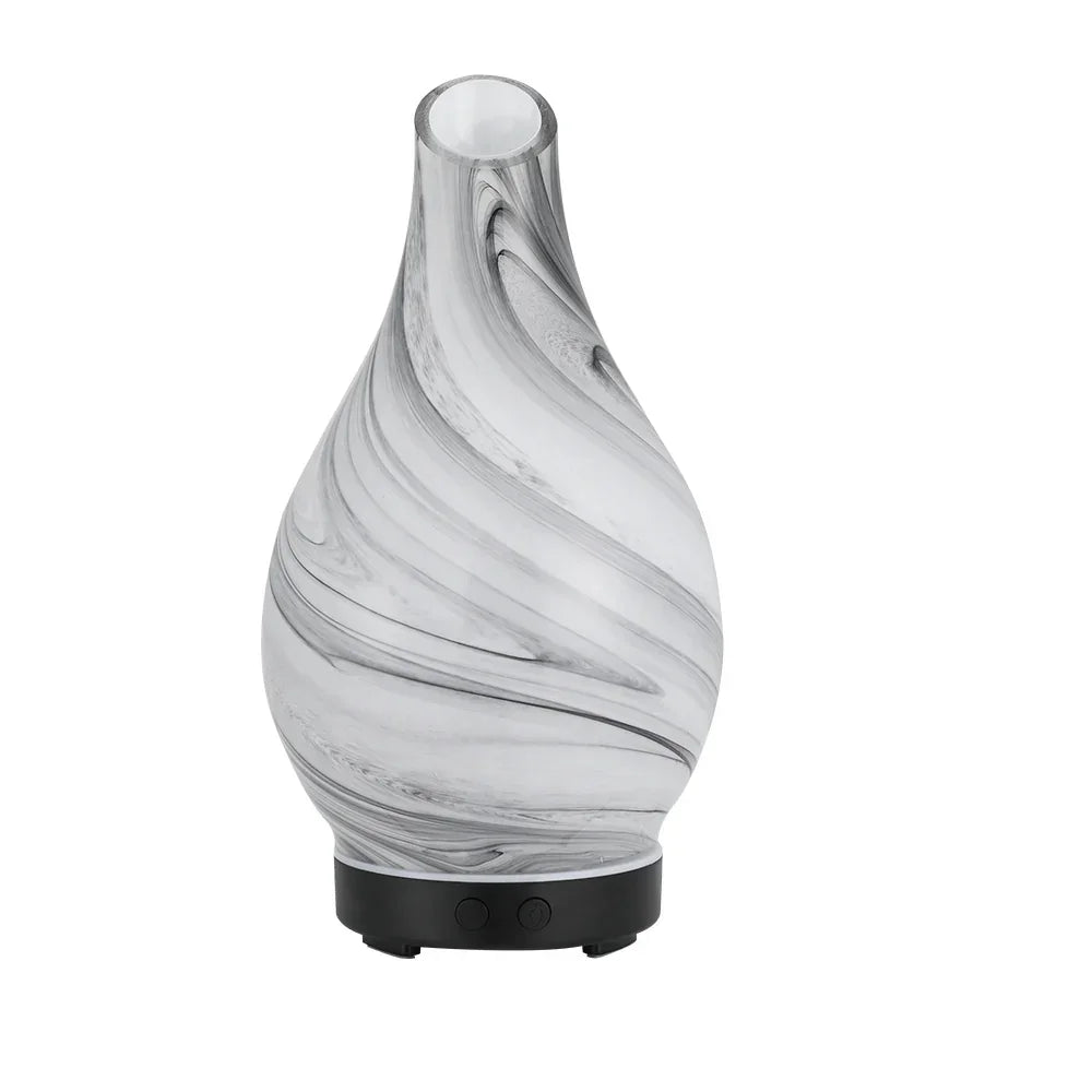 Marbled glass electric diffuser with black base, swirl pattern, two control buttons