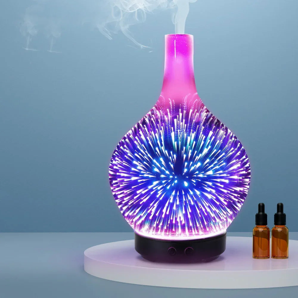 Aromatherapy diffuser with colorful LED lights and two essential oil bottles on a round tray