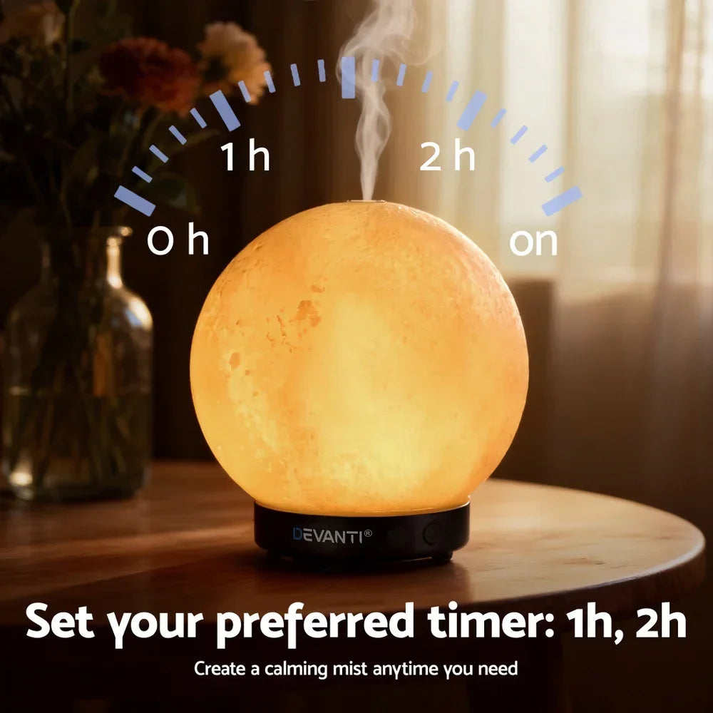 Moon-shaped aroma diffuser with calming mist and timer, sitting on a wooden table.