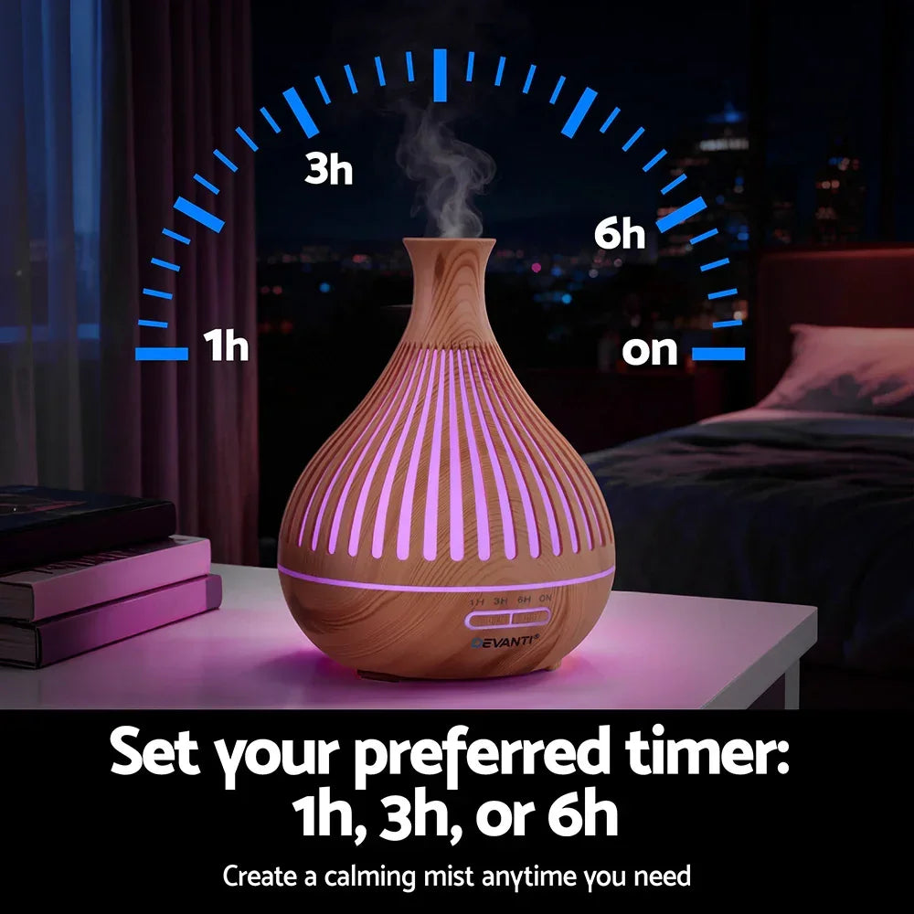 Wood grain essential oil diffuser with LED light and timer settings on a nightstand at night.