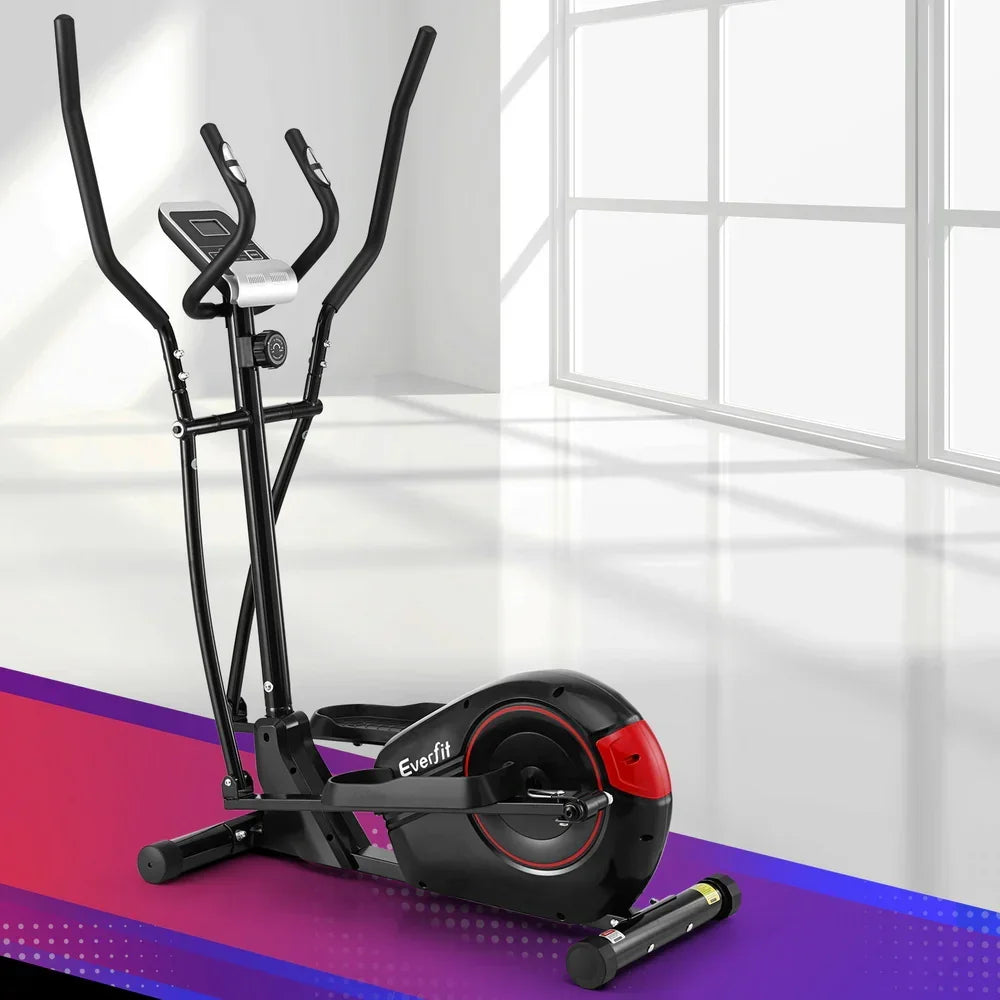 Black and red elliptical cross trainer exercise machine in sunlit indoor gym setting.
