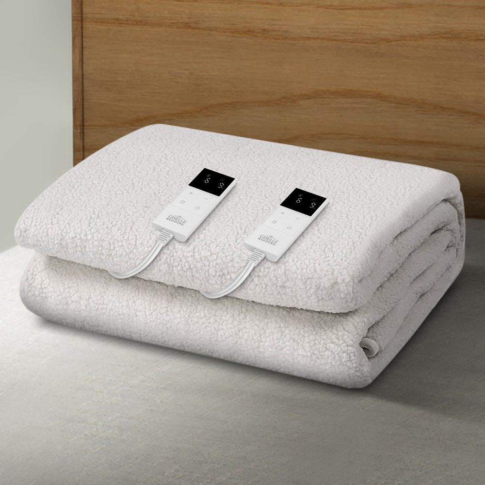 White electric heated blanket with dual digital controllers on a bed.