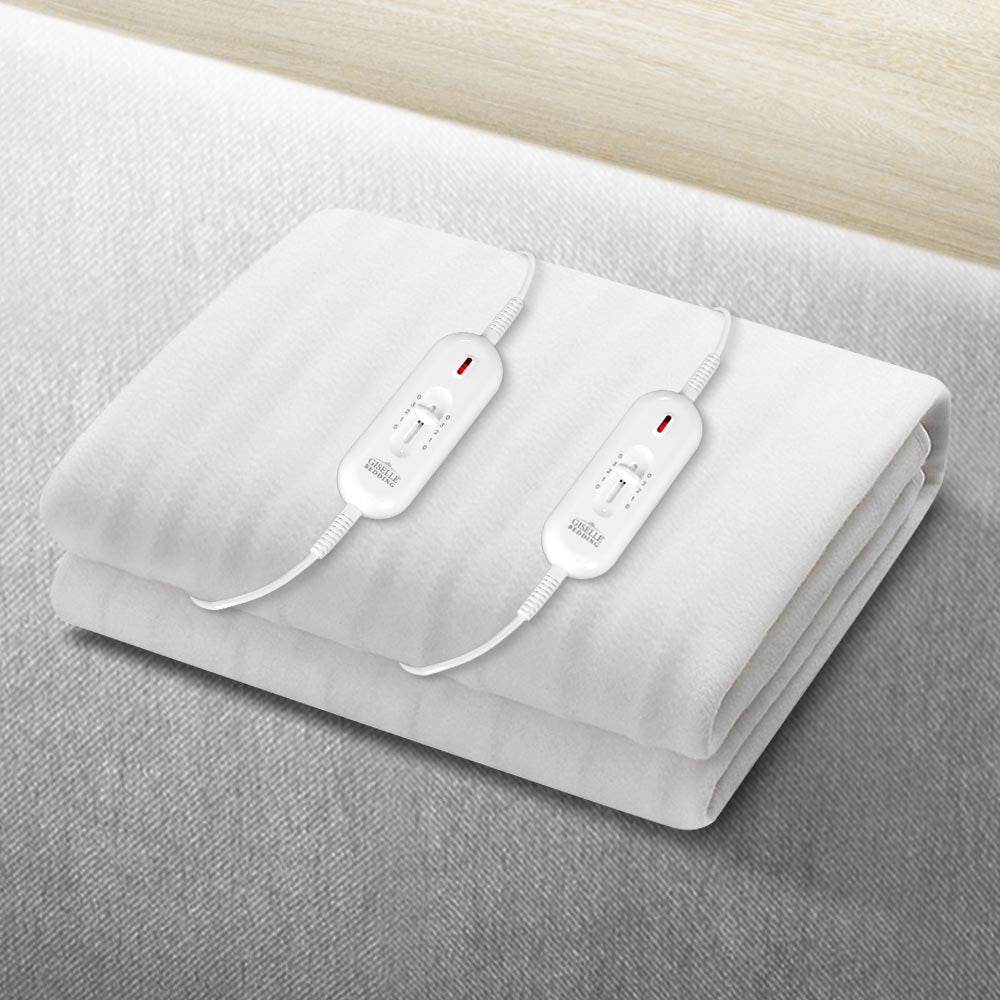 White electric blanket with dual controllers placed on a bed, twin adjustable heat settings