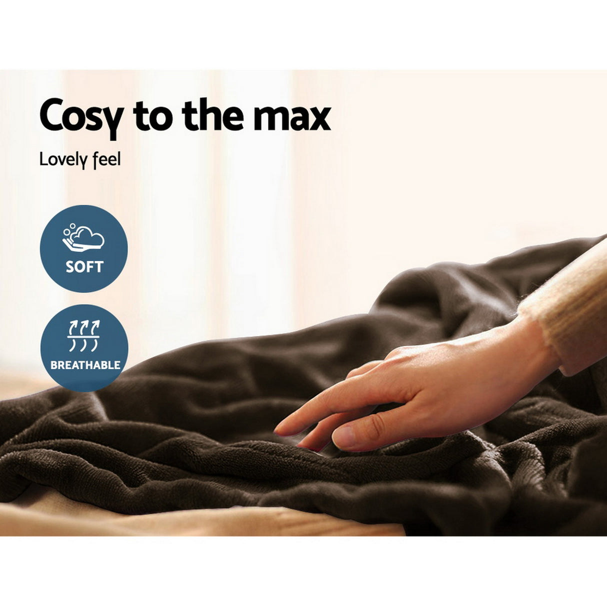 Hand touching a soft, breathable, dark throw rug on a bed in a cozy indoor setting.