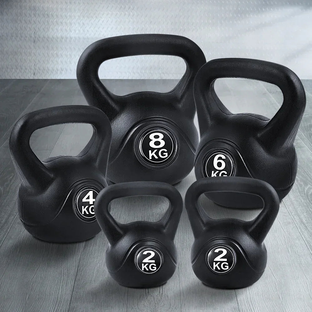 Set of black kettlebells in 2kg, 4kg, 6kg, and 8kg on a gym floor