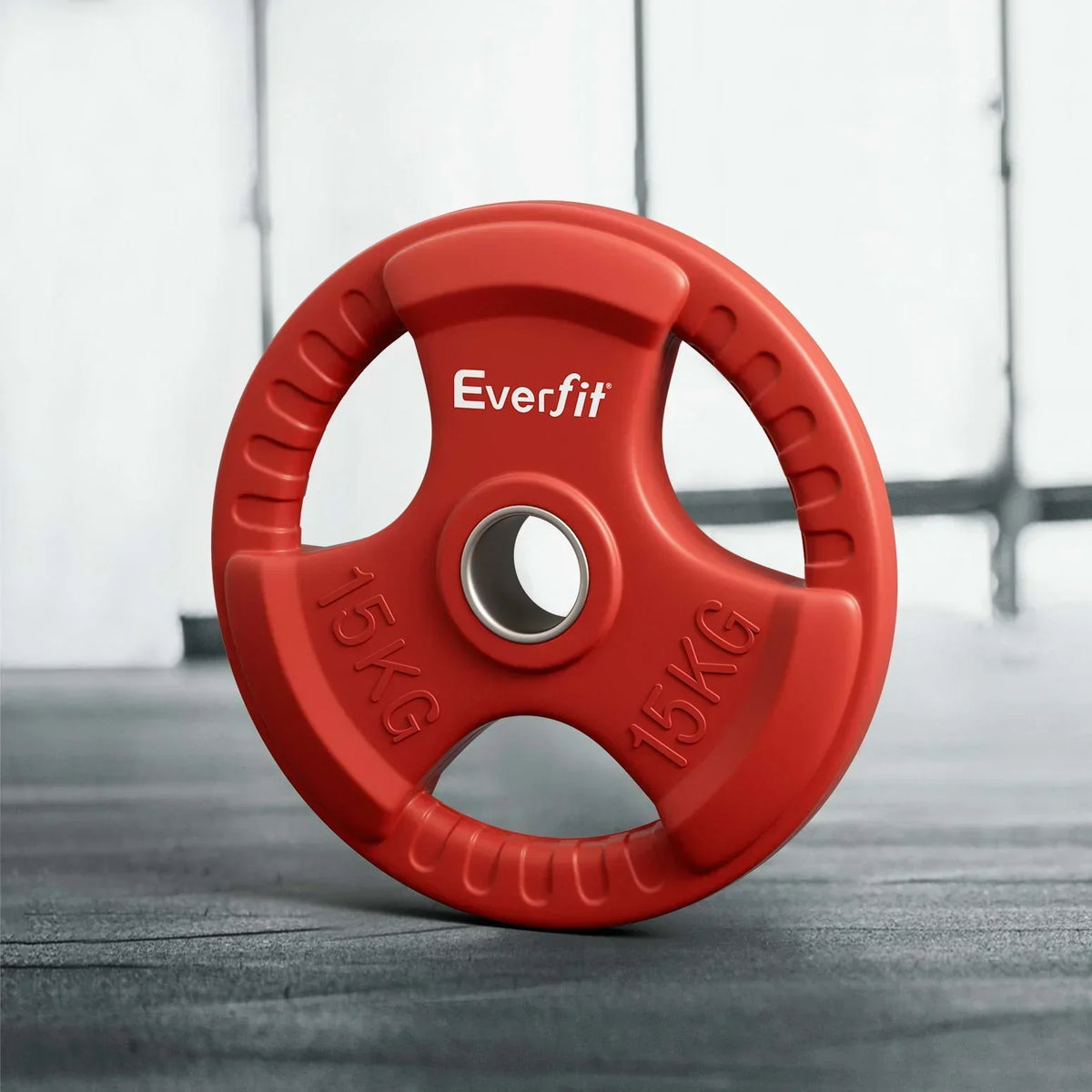 Red 15KG Everfit weight plate with grip handles on gym floor