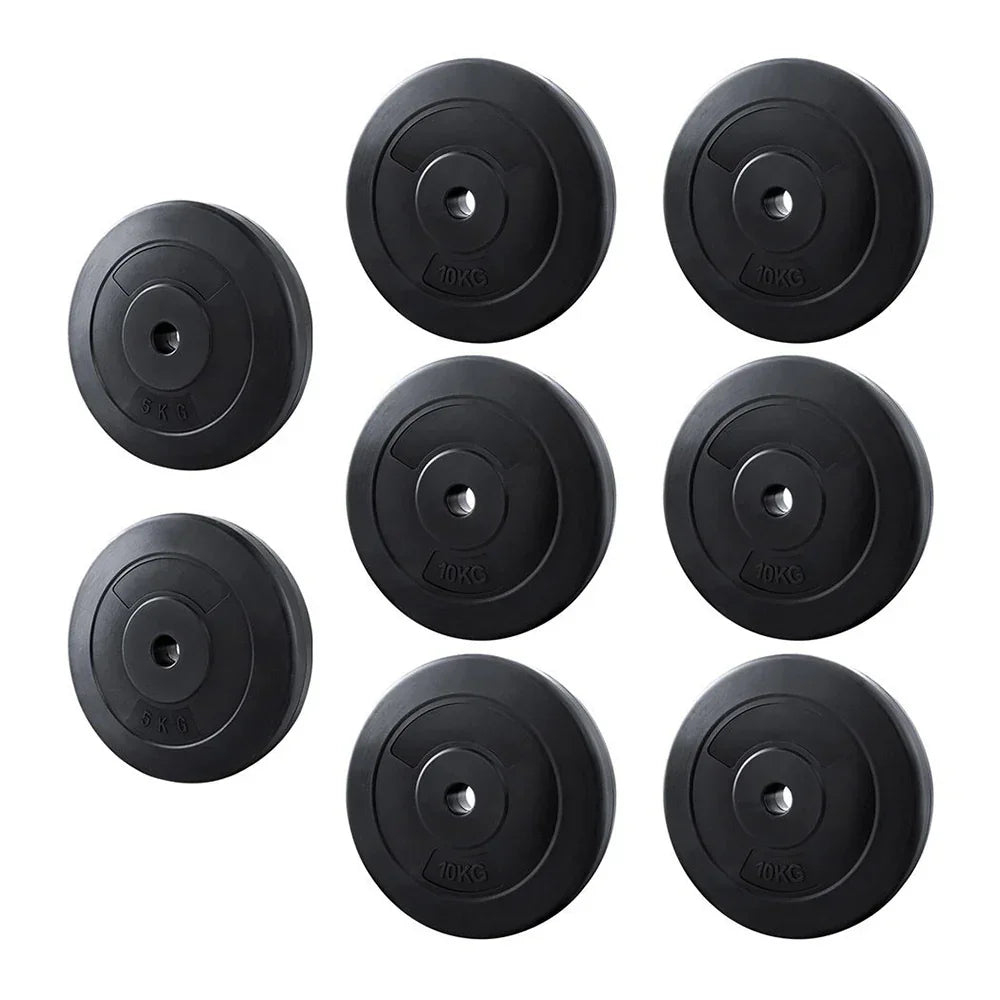 Set of eight black weight plates, 5kg and 10kg, for home gym or barbell training
