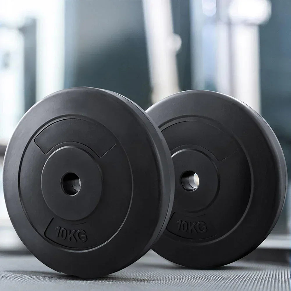 Pair of 10kg black weight plates for gym or home workout on gym floor