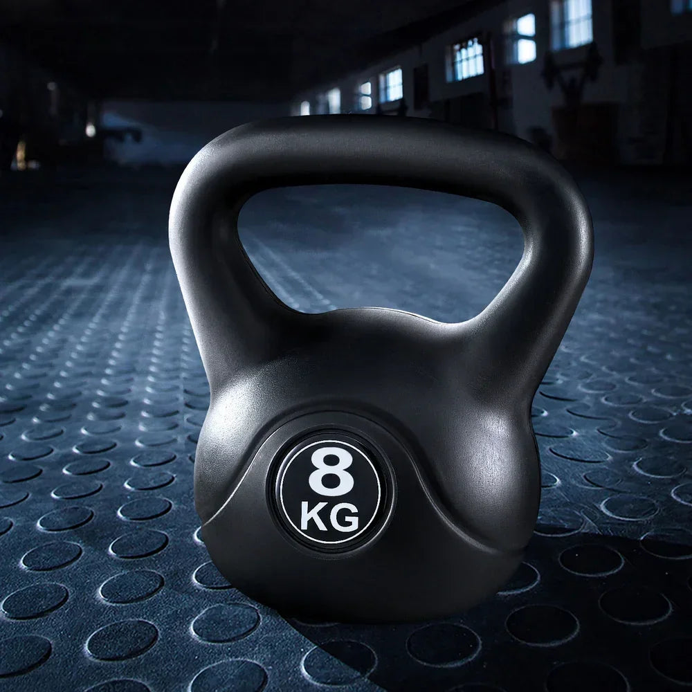 Black 8kg kettlebell on a rubber gym floor, fitness equipment close-up