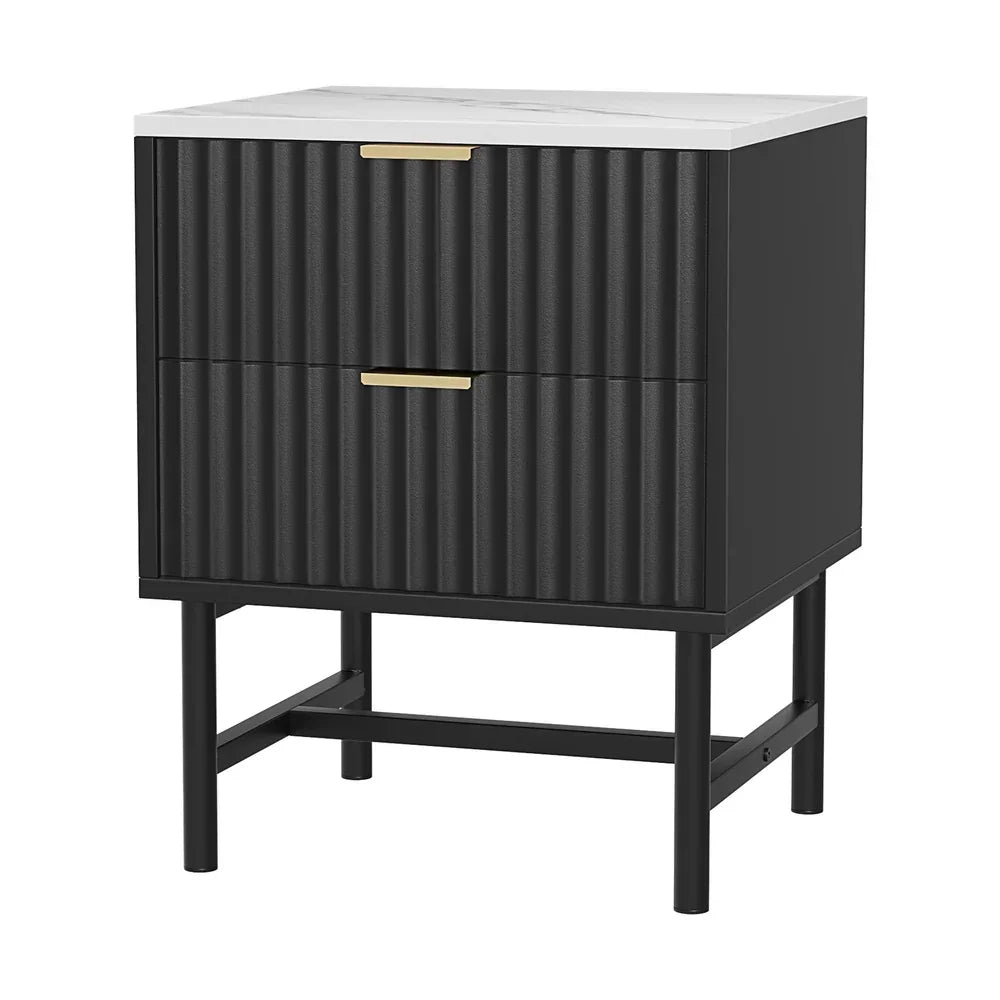 Black bedside table with fluted drawers, gold handles, and white marble top