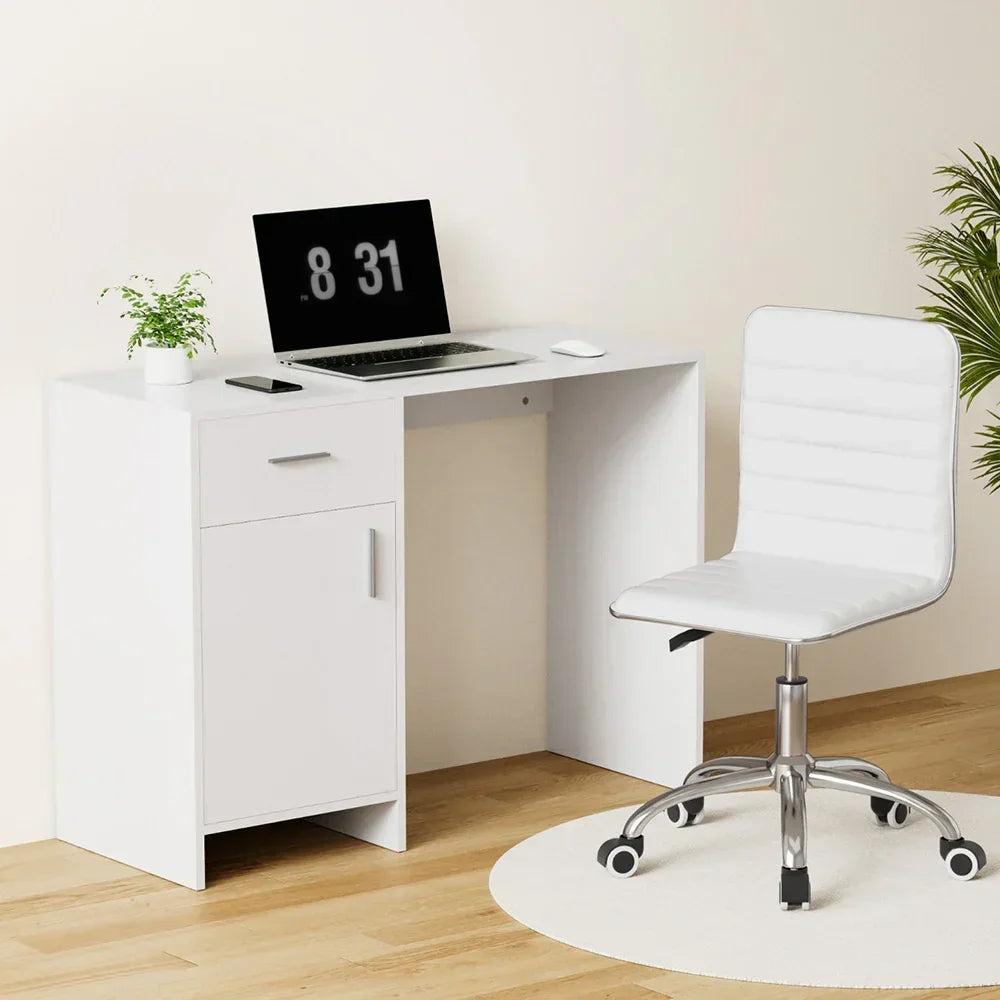 Modern white office desk with storage, laptop, and white swivel chair on wooden floor