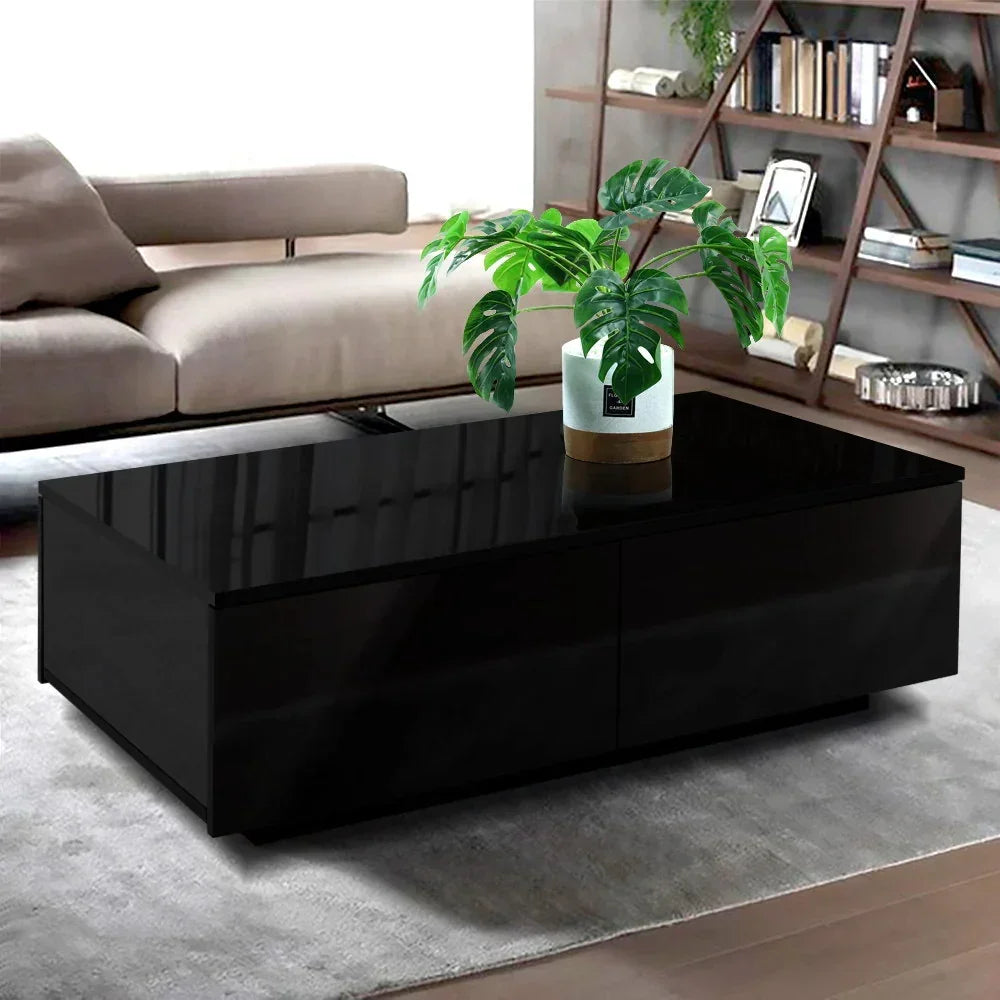 Modern black coffee table with glossy finish and potted plant in a stylish living room