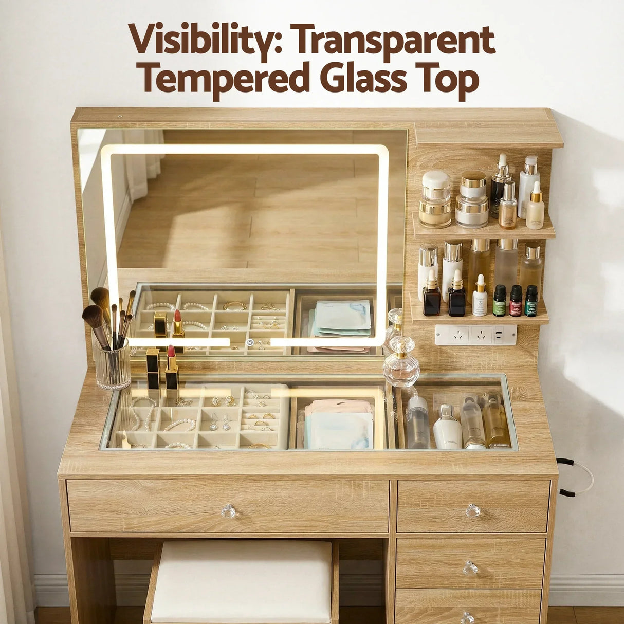 Wooden dressing table with LED mirror, transparent glass top, organizers, and cosmetics.