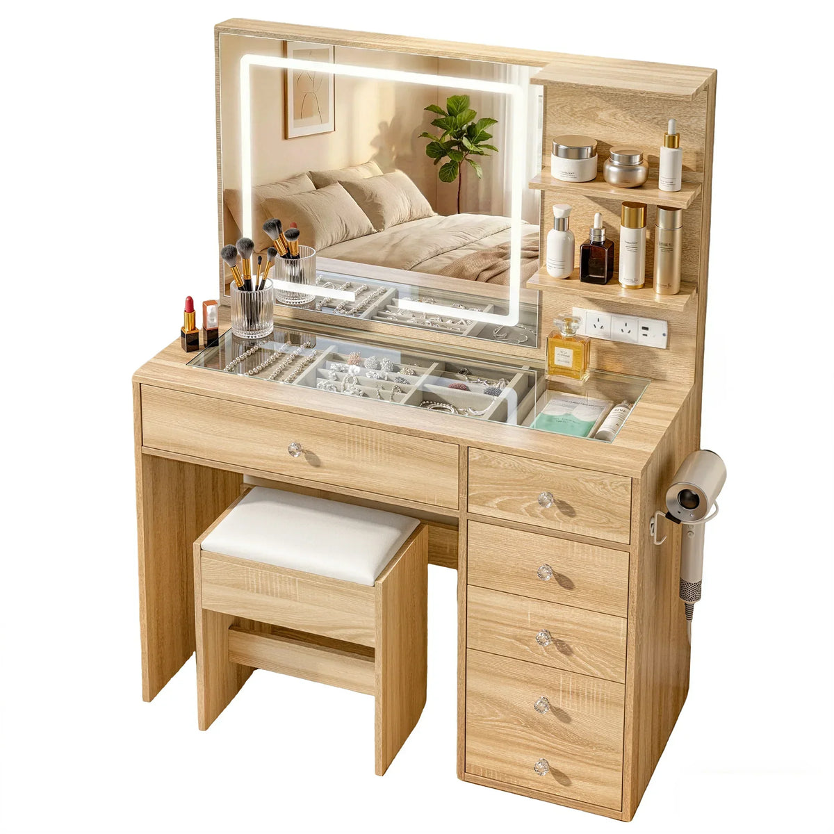 Light wood vanity table with mirror, drawers, shelves, and beauty accessories in a bedroom.