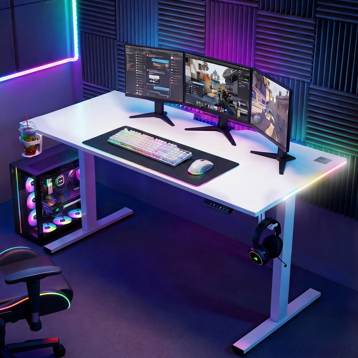 Gaming desk setup with RGB keyboard, triple monitors, PC tower, and neon lights for immersive play