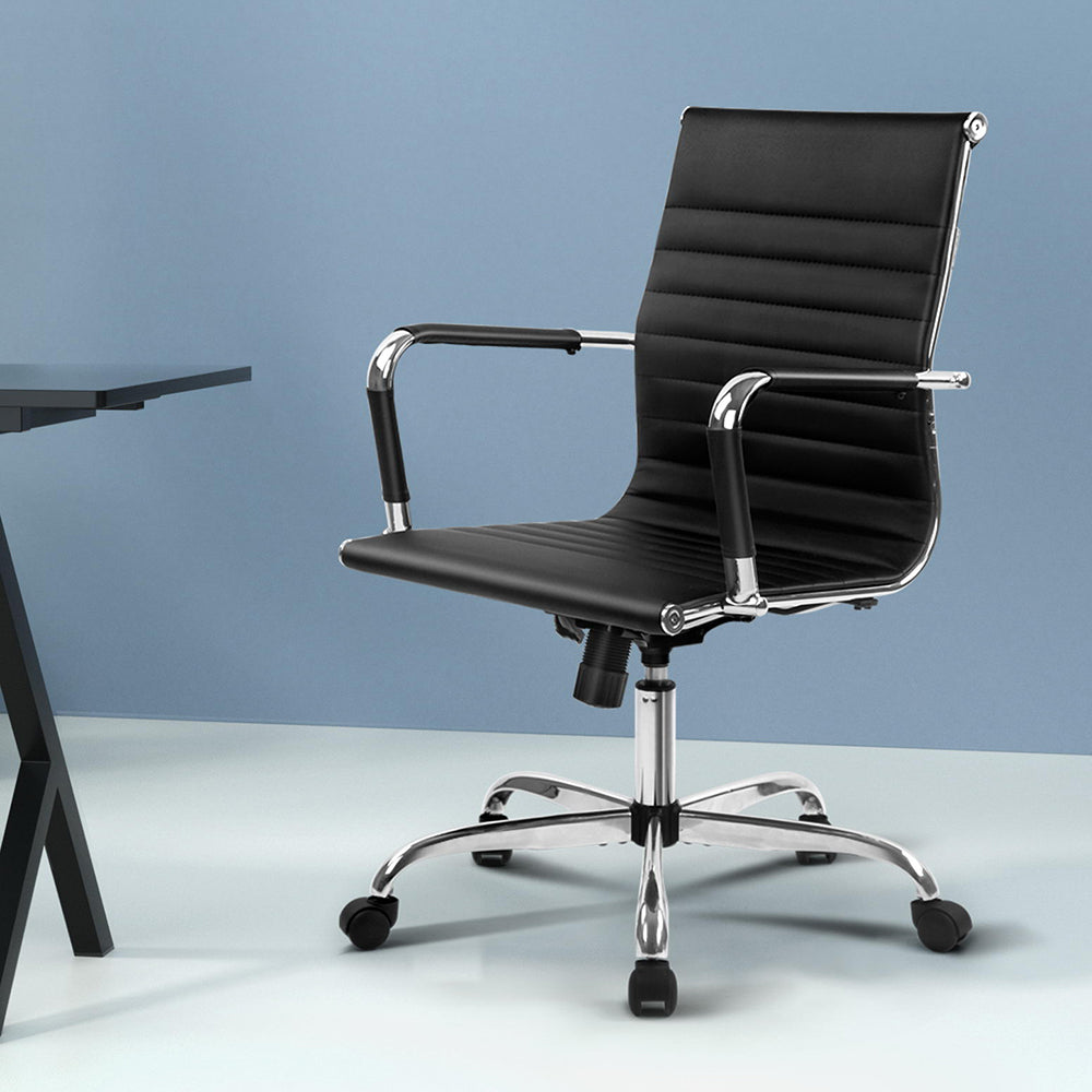 Black office chair with chrome base and armrests, ideal for home or workspace comfort