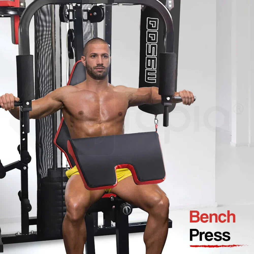 Man using a home gym machine for bench press workout, wearing yellow shorts in a fitness room.
