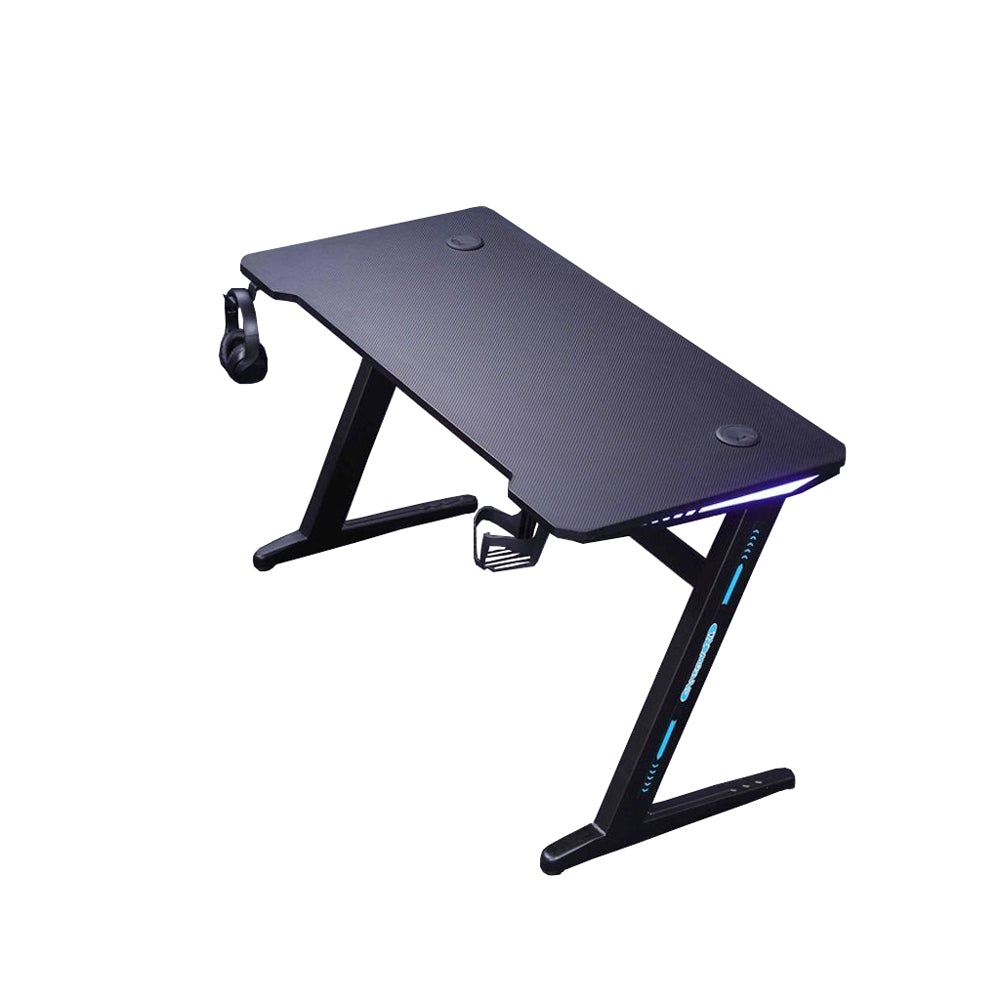 Black gaming desk with RGB lighting, headphone hook, and cable management for PC setup