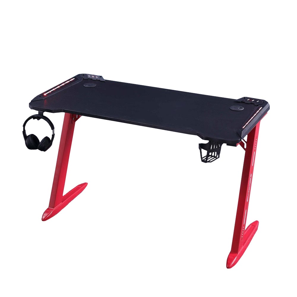 Black gaming desk with red legs, headphone hook, and cup holder for PC setup