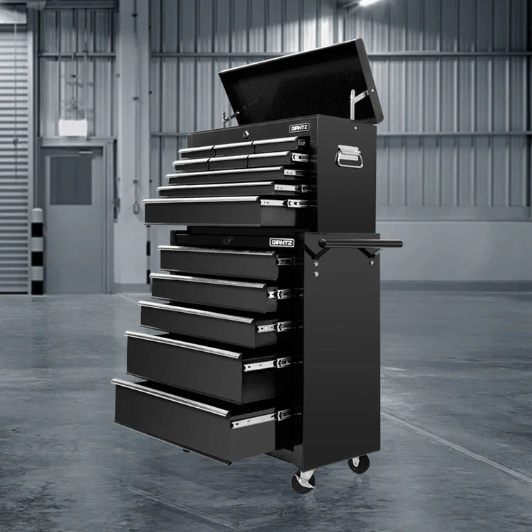 Black GRNTZ brand rolling metal tool chest with multiple open drawers in industrial workshop