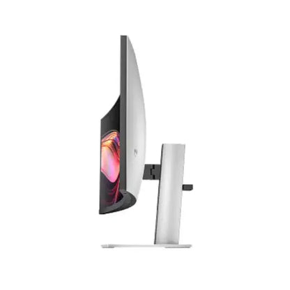 Side view of a curved computer monitor with slim bezel and silver stand on white background