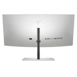 Back view of curved ultra-wide computer monitor with multiple ports and silver stand