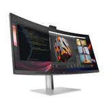 Curved ultrawide computer monitor on a stand displaying multitasking windows