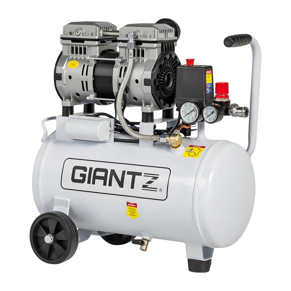 White portable air compressor with pressure gauges and wheels, suitable for workshops or garages.