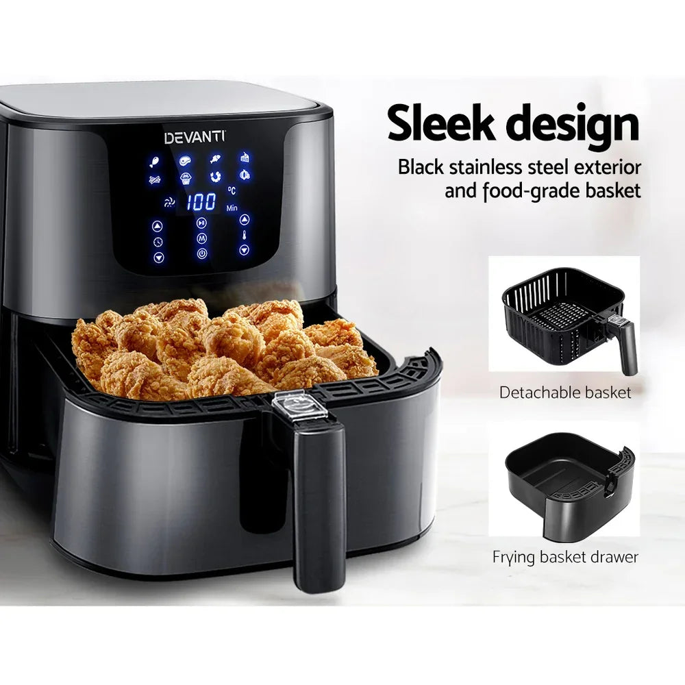 Black digital air fryer with touchscreen, detachable basket, and fried chicken inside.