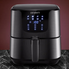 Black digital air fryer with LED touchscreen controls on marble countertop