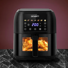Black digital air fryer with illuminated control panel and fried chicken inside