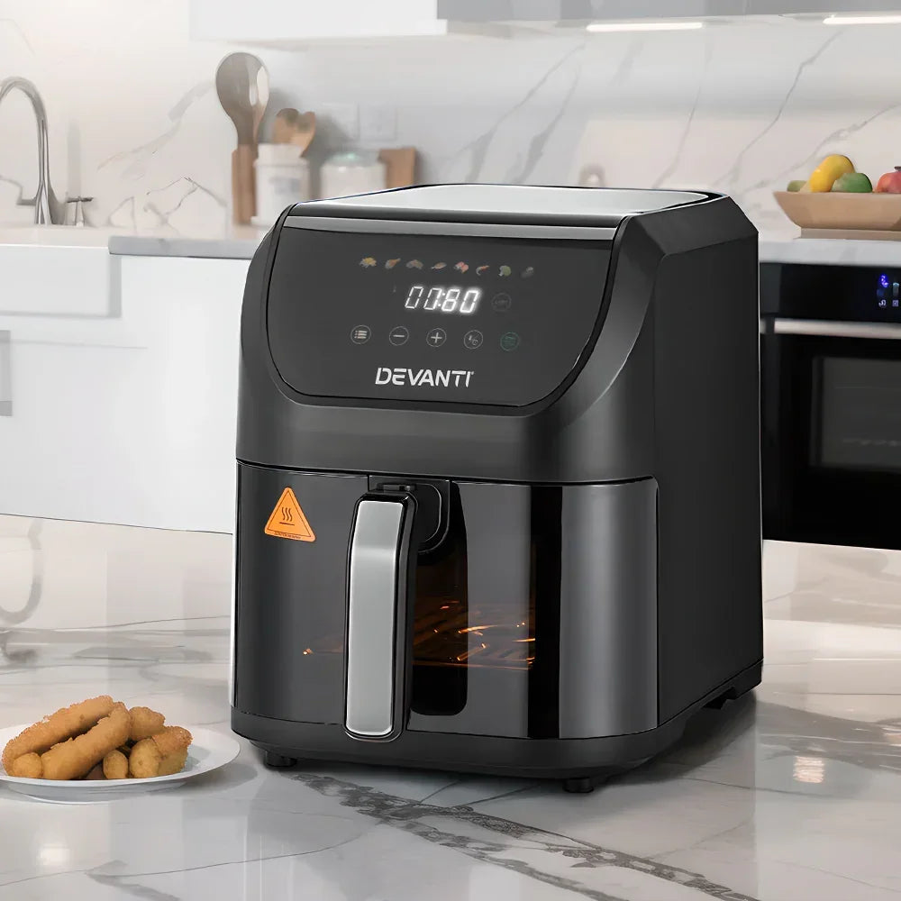 Black digital air fryer with LED display on kitchen countertop, plate of snacks beside it