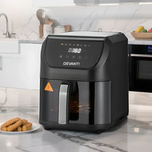 Black digital air fryer with LED display on kitchen countertop, plate of snacks beside it