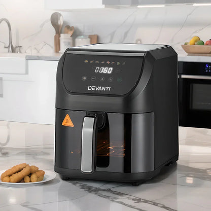Black digital air fryer with LED display on kitchen countertop, plate of snacks beside it