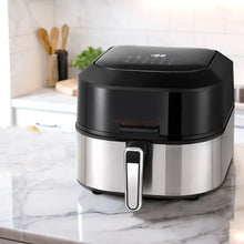 Modern stainless steel air fryer with digital display on kitchen countertop