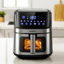 Stainless steel air fryer with digital display cooking crispy chicken in a modern kitchen