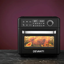 Black digital air fryer oven with touchscreen panel, cooking roast chicken and vegetables.