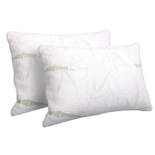 Pair of white, patterned bed pillows with subtle green accents on a plain background