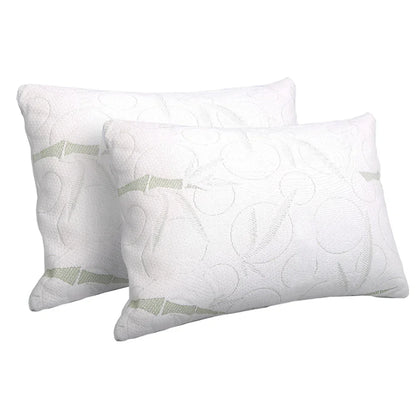 Pair of white, patterned bed pillows with subtle green accents on a plain background