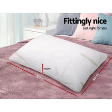 Rectangular white pillow on a bed with size dimensions 70cm x 40cm x 19cm shown