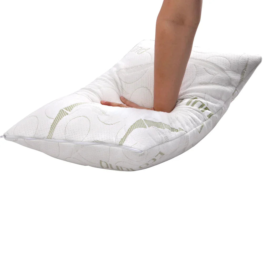 Hand pressing down on a soft white bamboo memory foam pillow on white background