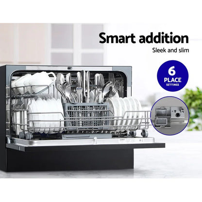 Compact countertop dishwasher with open door, loaded with plates, cups, and cutlery, 6 place settings