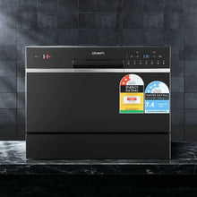 Black benchtop dishwasher with control panel, energy and water rating stickers, modern kitchen