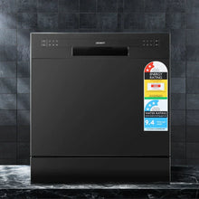 Black freestanding dishwasher with control panel and energy rating labels on tiled background